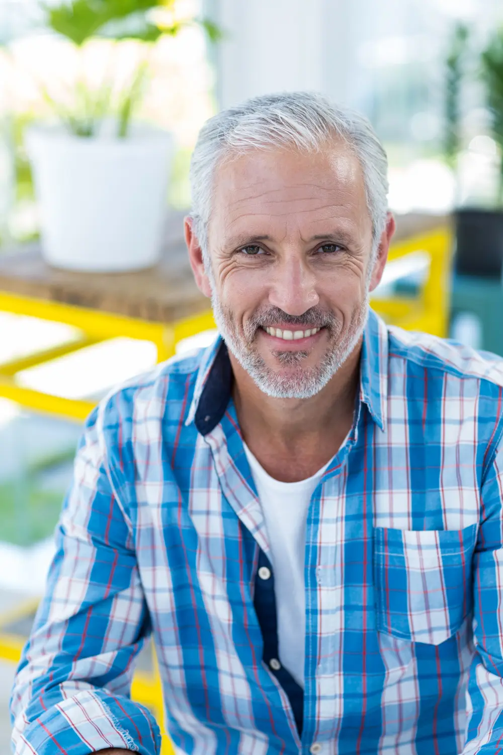 Happy middle-aged man smiling outdoors requiring Eugene Preventive Dentistry.